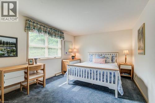 Carpeted room with a large window featuring horizontal blinds - 97 Somerset Crescent, Waterloo, ON - Indoor Photo Showing Bedroom