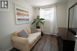 Bright room with wood-finish flooring, a window, and a built-in mirror - 