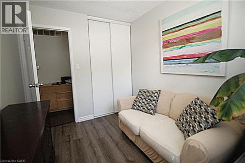 Wood-finish flooring, white walls, and a built-in closet with sliding doors - 35 Garden Crescent, Hamilton, ON - Indoor