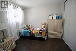 Wood-finish flooring with a white wall finish and a built-in sliding closet - 