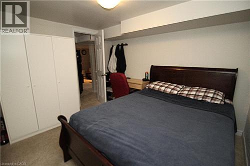 Built-in wardrobes with white panel doors - 35 Garden Crescent, Hamilton, ON - Indoor Photo Showing Bedroom
