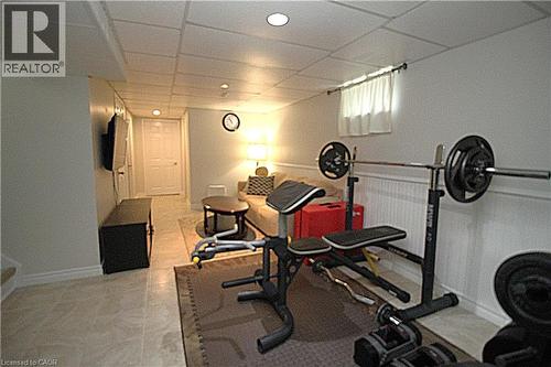 Recessed lighting, tile flooring, paneled walls, and a window with white curtains - 35 Garden Crescent, Hamilton, ON - Indoor