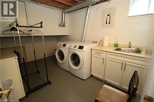 Laundry area featuring a utility sink, built-in cabinetry, and overhead window - 35 Garden Crescent, Hamilton, ON - Indoor Photo Showing Laundry Room