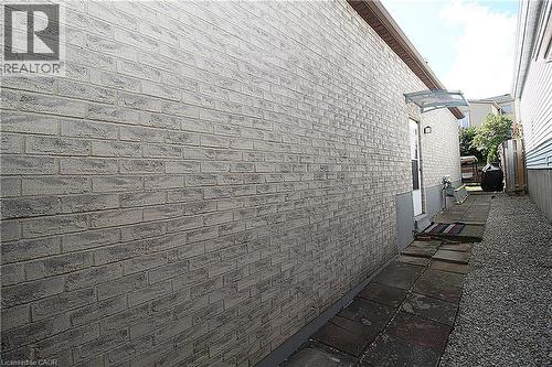 Light-colored brick exterior with a protective awning over the entry - 35 Garden Crescent, Hamilton, ON - Outdoor