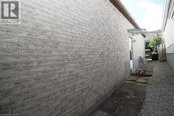 Light-colored brick exterior with a protective awning over the entry - 