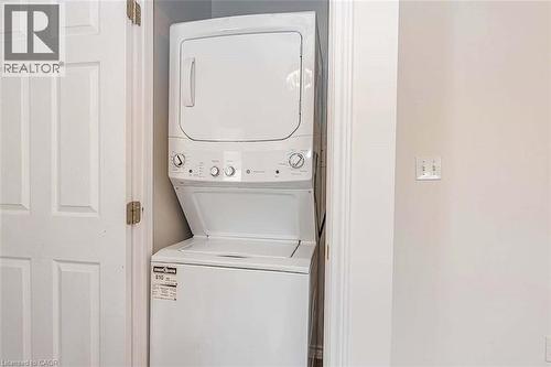 Stacked white washer and dryer unit - 47 Queensway Drive, Strathroy, ON - Indoor Photo Showing Laundry Room