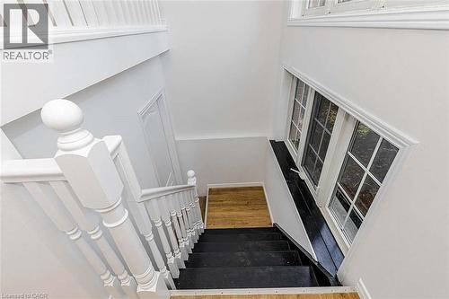 Painted white balusters and newel posts with a classic design - 47 Queensway Drive, Strathroy, ON - Indoor Photo Showing Other Room