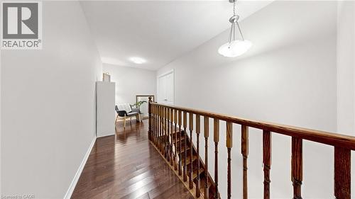 Hardwood flooring, painted walls, pendant light fixture, recessed lighting, and a white door - 173 Raymond Road, Ancaster, ON - Indoor Photo Showing Other Room