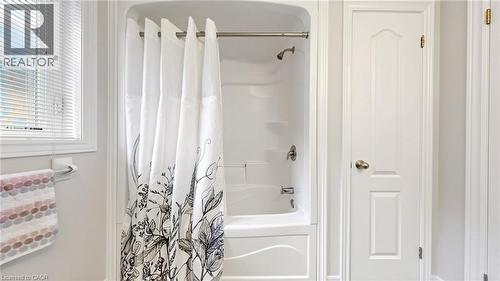 White bath-shower combination with a chrome shower head and faucet - 173 Raymond Road, Ancaster, ON - Indoor Photo Showing Bathroom