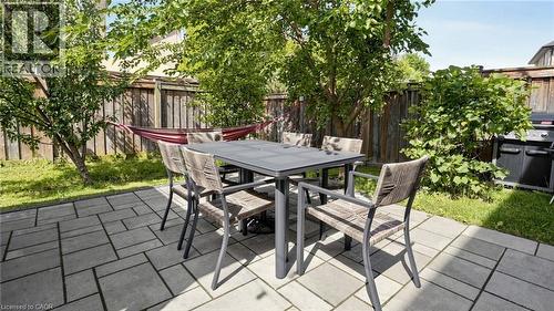 Paved patio featuring a geometric pattern and surrounding green spaces - 173 Raymond Road, Ancaster, ON - Outdoor With Deck Patio Veranda