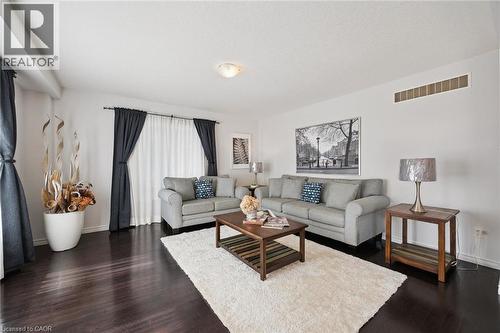 Hardwood-finish flooring, recessed ceiling lighting, and large windows with curtain rods - 360 Freure Drive, Cambridge, ON - Indoor Photo Showing Living Room