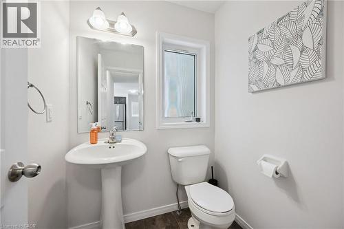 Pedestal sink with chrome faucet, framed mirror, and overhead vanity lighting - 360 Freure Drive, Cambridge, ON - Indoor Photo Showing Bathroom