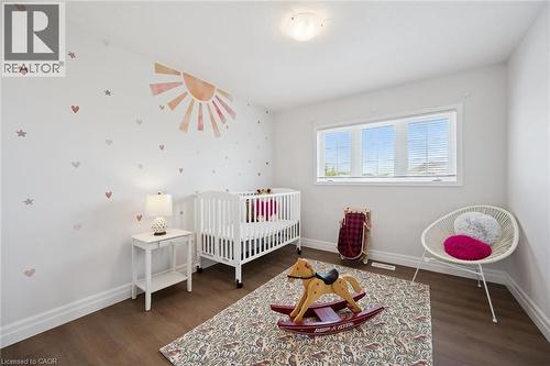 Wood-finish flooring, white trim, and a white ceiling-mounted light fixture - 360 Freure Drive, Cambridge, ON - Indoor Photo Showing Bedroom