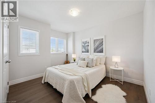 White walls with dark wood-finish flooring - 360 Freure Drive, Cambridge, ON - Indoor Photo Showing Bedroom