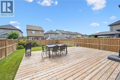 Expansive wood-plank deck with a perimeter wood fence, featuring a grassy lawn area - 360 Freure Drive, Cambridge, ON - Outdoor With Deck Patio Veranda With Exterior