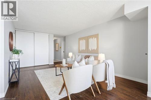 Dark wood-finish flooring complements the light wall tones - 375 King Street N Unit# 708, Waterloo, ON - Indoor