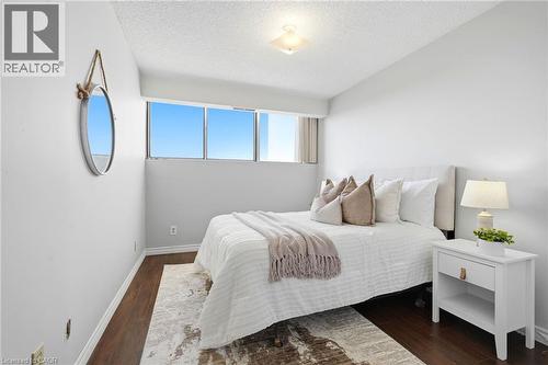 Hardwood-style flooring, white walls, large windows, and a flush-mount ceiling light - 375 King Street N Unit# 708, Waterloo, ON - Indoor Photo Showing Bedroom
