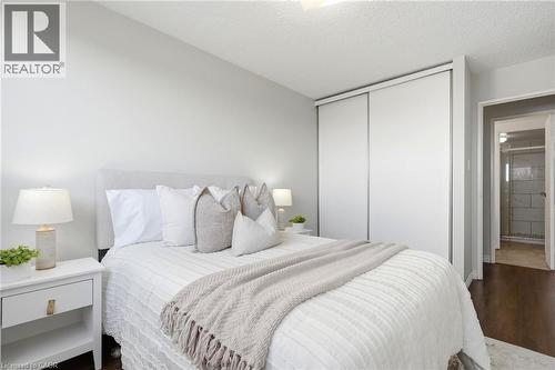 Wood-finish flooring, light grey wall paint, and white sliding closet doors - 375 King Street N Unit# 708, Waterloo, ON - Indoor Photo Showing Bedroom