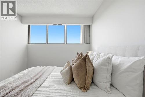 White walls with a textured ceiling and full-height windows - 375 King Street N Unit# 708, Waterloo, ON - Indoor Photo Showing Bedroom