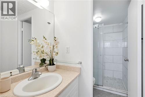 Vanity with an integrated sink, polished chrome faucet, and expansive wall-mounted mirror - 375 King Street N Unit# 708, Waterloo, ON - Indoor Photo Showing Bathroom