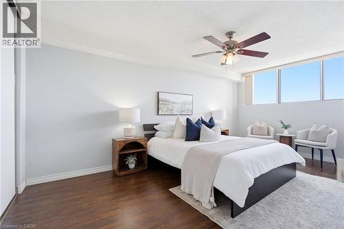 Wood-finish flooring with a light-toned ceiling, featuring a ceiling fan with integrated lighting - 375 King Street N Unit# 708, Waterloo, ON - Indoor Photo Showing Bedroom