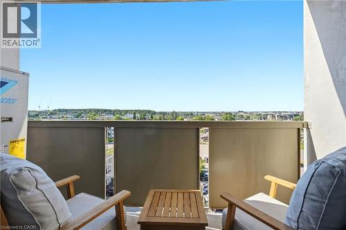 Balcony with a solid privacy barrier and an urban tree-lined horizon - 375 King Street N Unit# 708, Waterloo, ON - Outdoor With Exterior