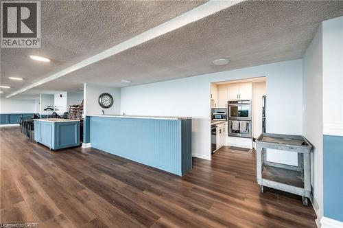 Wood-finish flooring, recessed lighting, and a built-in kitchen with wall oven and microwave - 375 King Street N Unit# 708, Waterloo, ON - Indoor