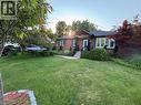 Brick exterior with a dark shingle roof, white trim windows, and a prominent front door - 2105 Maplewood Drive, Burlington, ON  - Outdoor 