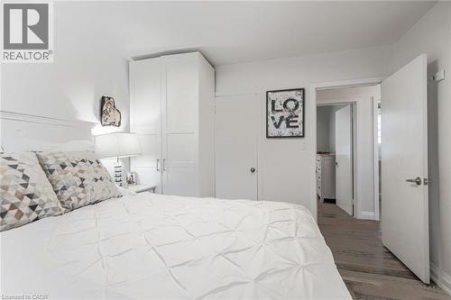 Built-in cabinetry, wood-finish flooring, and white interior doors - 2105 Maplewood Drive, Burlington, ON - Indoor Photo Showing Bedroom