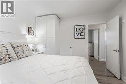 Built-in cabinetry, wood-finish flooring, and white interior doors - 