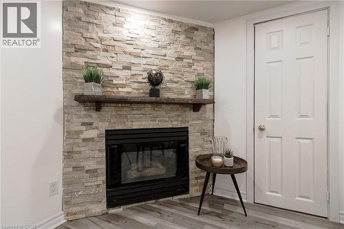 Stone-clad fireplace with a wood mantel - 2105 Maplewood Drive, Burlington, ON - Indoor Photo Showing Living Room With Fireplace