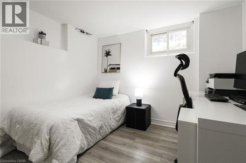 Wood-finish flooring with white walls and a white-framed window - 2105 Maplewood Drive, Burlington, ON - Indoor Photo Showing Bedroom