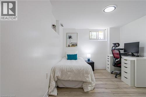 Recessed window, wood-finish flooring, built-in shelving, and a flush-mount ceiling light - 2105 Maplewood Drive, Burlington, ON - Indoor Photo Showing Bedroom