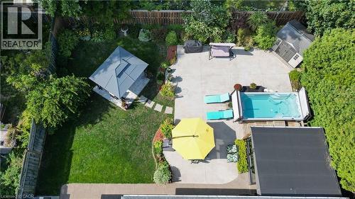 Expansive backyard featuring a swim spa, paved patio, manicured lawn, and a gazebo - 2105 Maplewood Drive, Burlington, ON - Outdoor