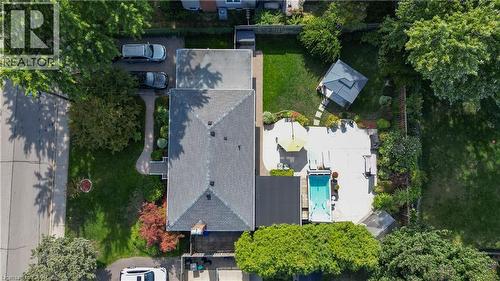 Manicured exterior featuring a large swimming pool, expansive concrete patio, and a covered gazebo - 2105 Maplewood Drive, Burlington, ON - Outdoor With View