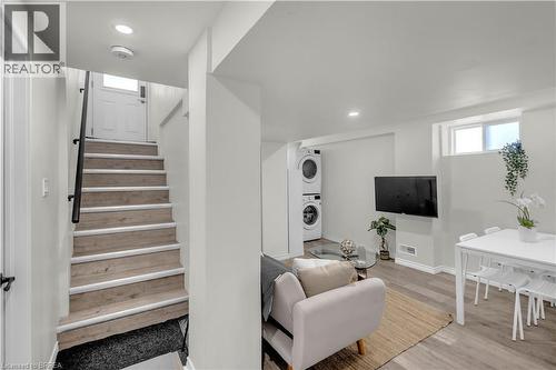 Hardwood-finish stairs with black handrail - 450 Highland Road E, Kitchener, ON - Indoor
