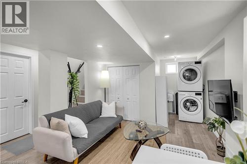 Open-concept living area featuring light wood-finish flooring, recessed lighting, and a neutral white color palette - 450 Highland Road E, Kitchener, ON - Indoor Photo Showing Laundry Room