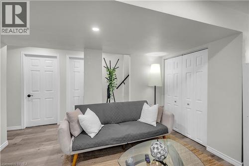 Living area featuring wood-finish flooring, recessed lighting, white paneled doors, and bi-fold closet doors - 450 Highland Road E, Kitchener, ON - Indoor