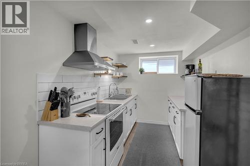 Ckitchen featuring white cabinetry, light countertops, and a white subway tile backsplash - 450 Highland Road E, Kitchener, ON - Indoor Photo Showing Kitchen