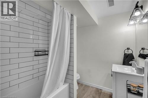 Lower Level Bathroom featuring a white subway tile shower surround, a white bathtub, and a vanity with a white basin sink - 450 Highland Road E, Kitchener, ON - Indoor Photo Showing Bathroom