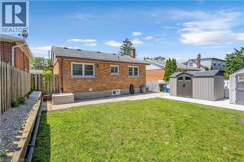 Expansive grassy yard with concrete patio areas - 450 Highland Road E, Kitchener, ON - Outdoor