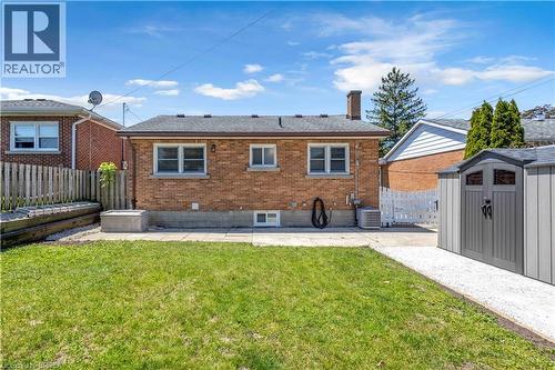 Brick exterior featuring a gabled roof and white window frames - 450 Highland Road E, Kitchener, ON - Outdoor