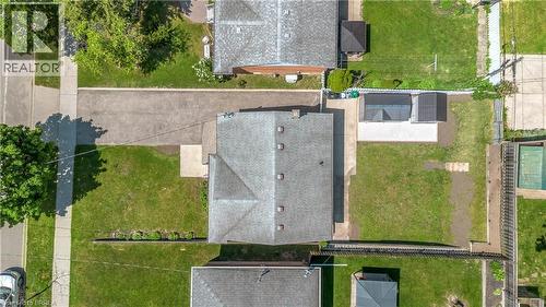 Expansive property with a central residence featuring a grey shingle roof and multiple skylights - 450 Highland Road E, Kitchener, ON - 