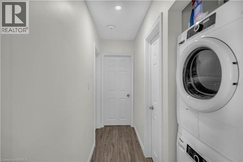 Main floor Dedicated laundry area featuring a stacked washer and dryer unit - 450 Highland Road E, Kitchener, ON - Indoor Photo Showing Laundry Room