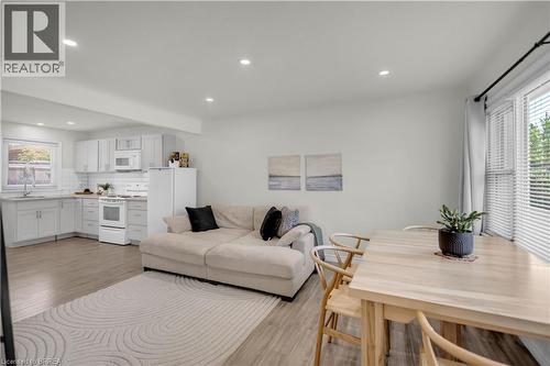 Open-concept living space featuring wood-finish flooring, recessed lighting, and white walls - 450 Highland Road E, Kitchener, ON - Indoor