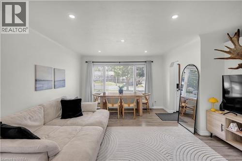 Open-concept living area featuring wood-finish flooring and recessed lighting - 450 Highland Road E, Kitchener, ON - Indoor Photo Showing Living Room
