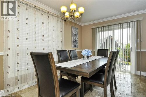 Crown molding accenting the ceiling, a built-in chandelier, and wall paneling - 156 Copper Leaf Street, Kitchener, ON - Indoor Photo Showing Dining Room