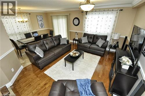 Hardwood flooring, recessed lighting, crown molding, and a built-in chandelier - 156 Copper Leaf Street, Kitchener, ON - Indoor Photo Showing Living Room
