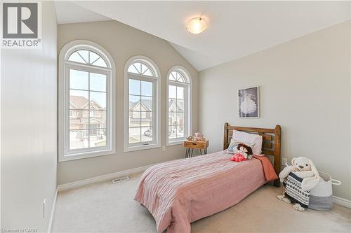Three arched windows with white frames, vaulted ceiling, light-toned wall paint, and plush carpeting - 24 Weatherall Avenue, Cambridge, ON - Indoor Photo Showing Bedroom