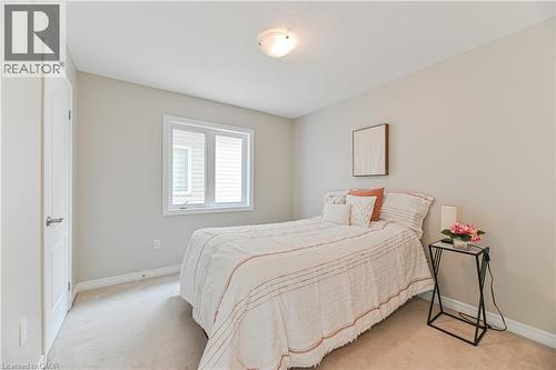 Neutral wall color, carpeted flooring, white trim, single window, and a flush-mount ceiling light fixture - 24 Weatherall Avenue, Cambridge, ON - Indoor Photo Showing Bedroom